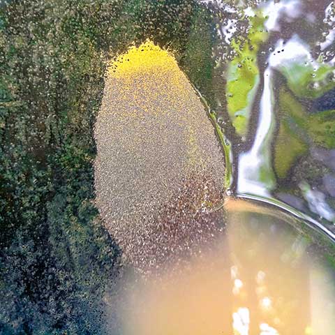 This image shows dust-like granules of gold being processed at an artisanal mining site in Burkina Faso. 