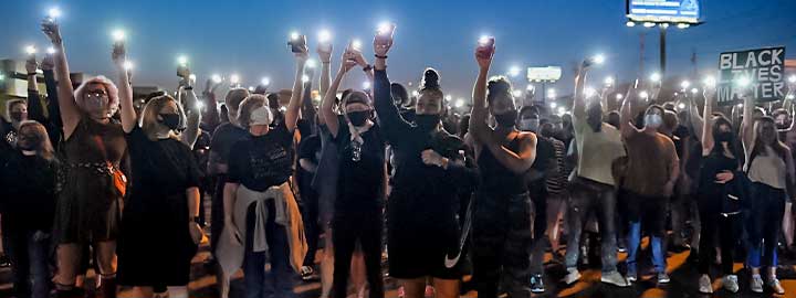 Protesters light up their cell phones on September 24, 2020 in St Louis, Missouri, at a demonstration after a grand jury's decision related to charges in the death of Breonna Taylor.      
