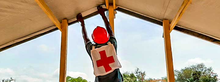 Central African Red Cross Society volunteers construct an isolation unit for people who have suspected cases of COVID--19.