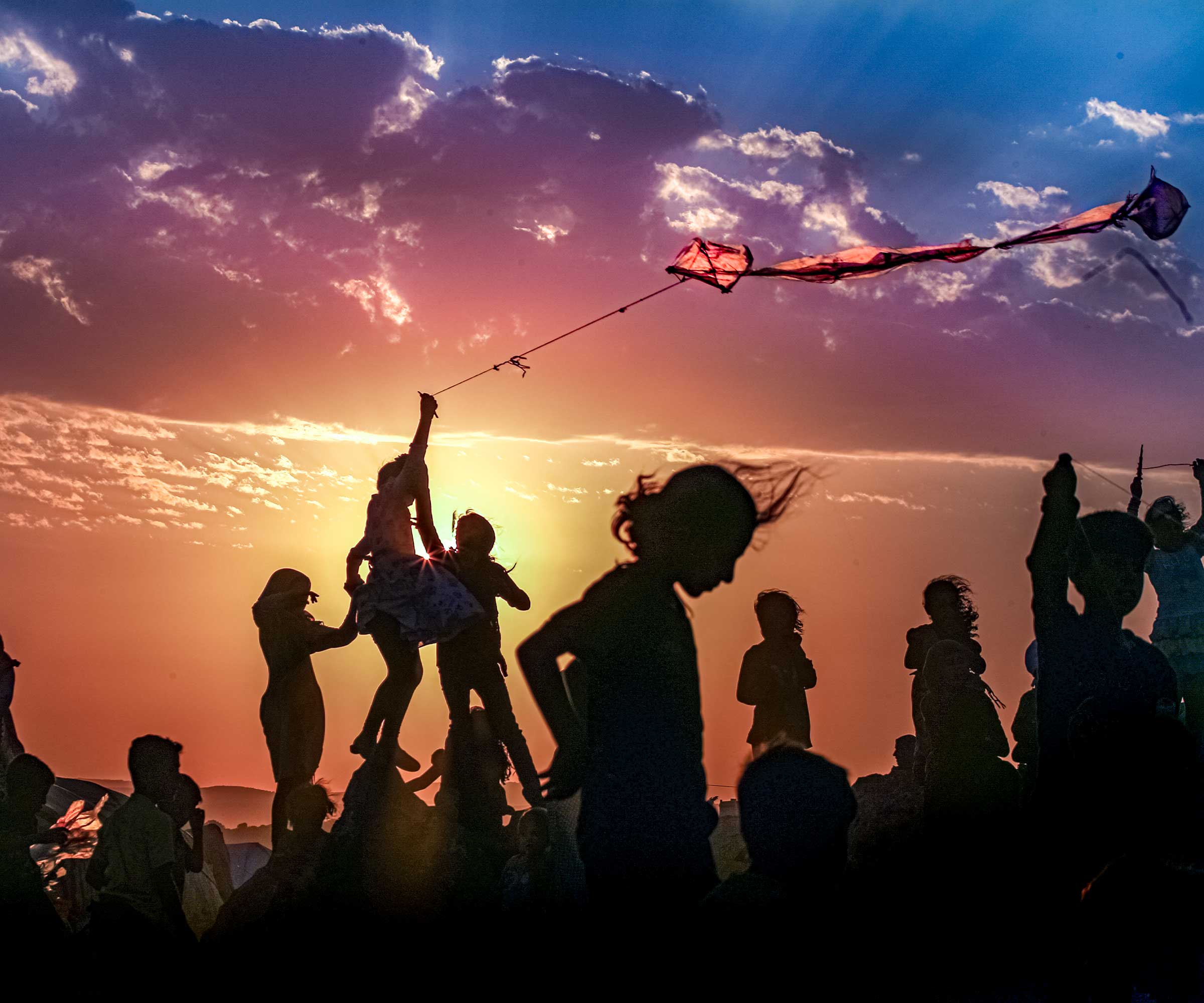 Syrian children fly kites at a refugee camp near the Turkish border. © Muhammed Said/Anadolu Agency/Getty Image