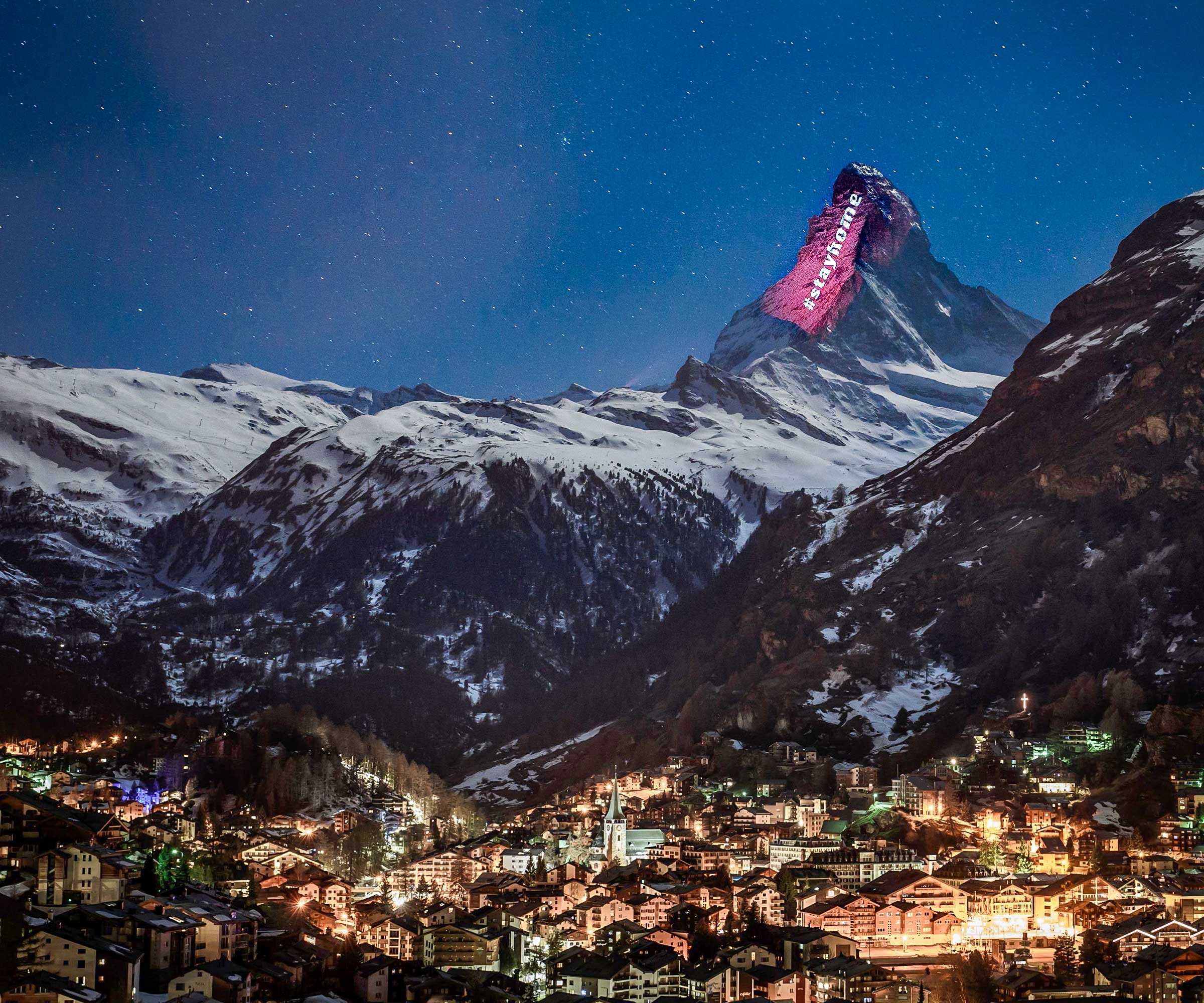 Above Zermatt, Switzerland, a light installation illuminates the alps. © Fabrice Coffrini/Getty Images