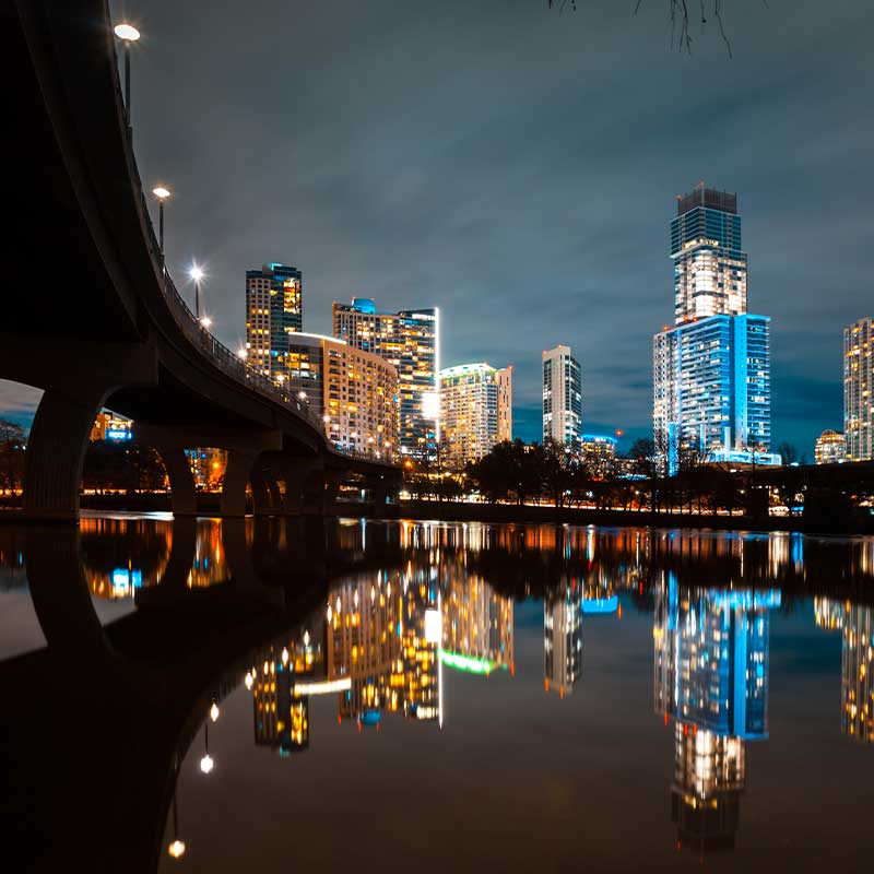 illuminated modern buildings by river