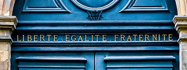 A photo of a door engraved with the words of the French Republican motto: Liberte, Egalite, Fraternite. 
