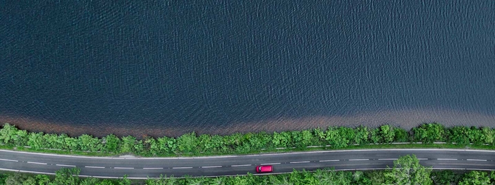 Road next to body of water aerial shot