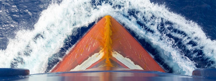 Aerial Top Down View Of A Motorboat Traveling Over Blue Sea