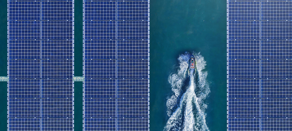 Bird’s-eye view of solar panels floating in a dam, providing a source of renewable energy