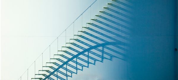 White staircase enveloped in shadow on an oil storage tank