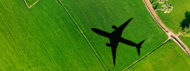 Shadow of an airplane cast on a grassy field