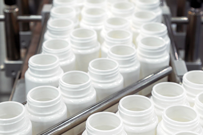 white plastic bottle on the production line of the conveyor
