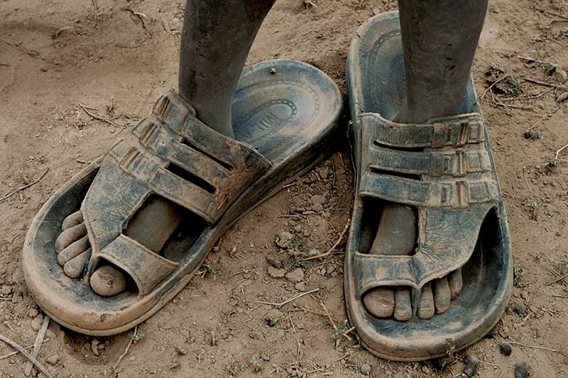 Boy standing in dirt