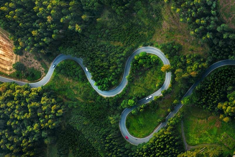 Winding road in the forest aerial shot