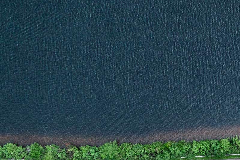 Road next to body of water aerial shot