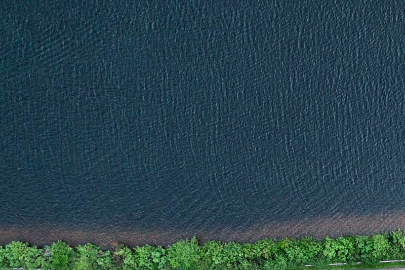 Road next to body of water aerial shot