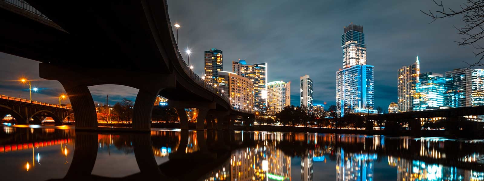 illuminated modern buildings by river