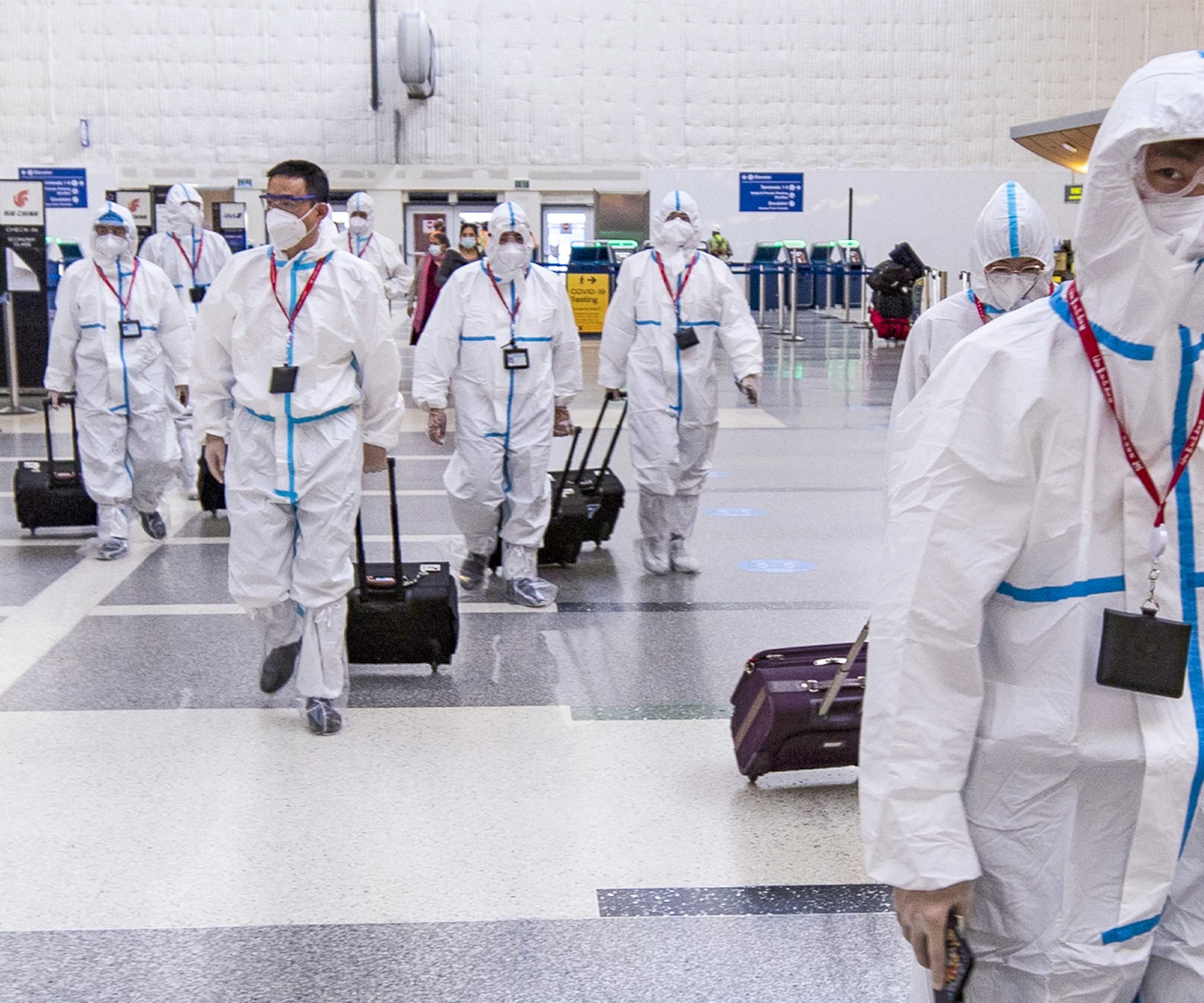 Airline crew members arrive at Los Angeles International Airport. © Etienne Lauren/EPA-EFE/Shutterstock